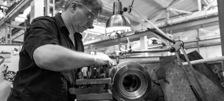 Photo of a man working with a lathe.